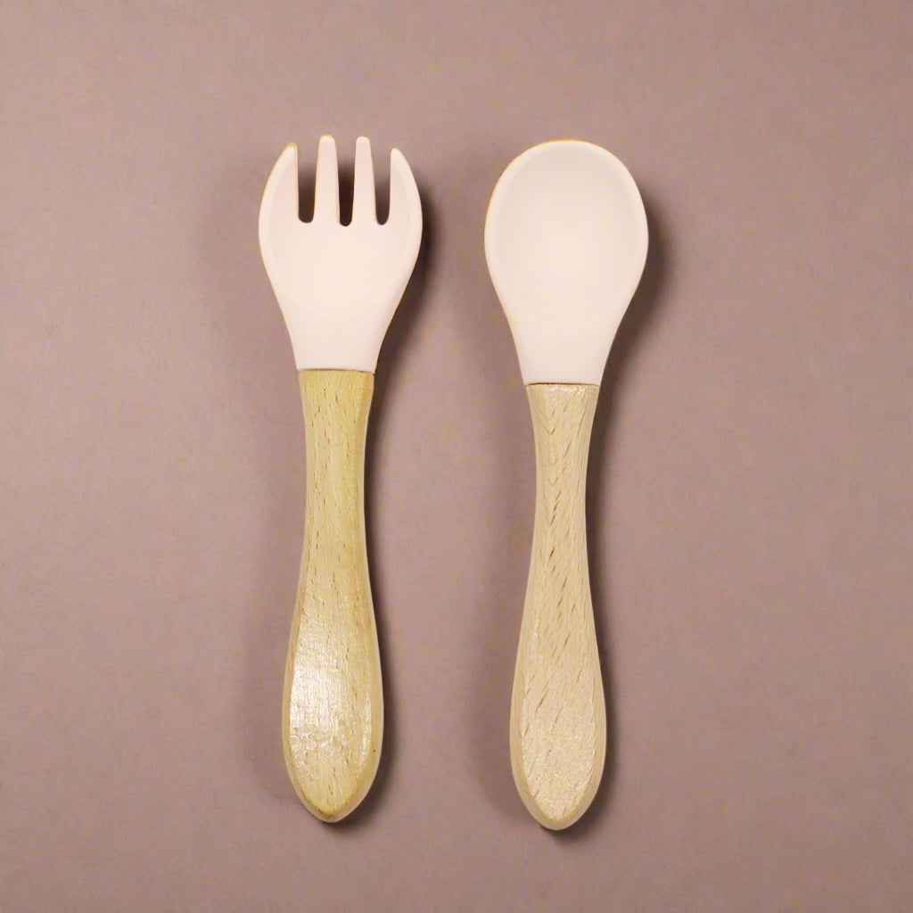 Ergonomic baby training fork and spoon set designed for self-feeding. BPA-free, non-toxic, and perfect for baby-led weaning and toddler meals.