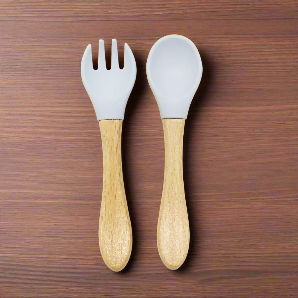 Ergonomic baby training fork and spoon set designed for self-feeding. BPA-free, non-toxic, and perfect for baby-led weaning and toddler meals.