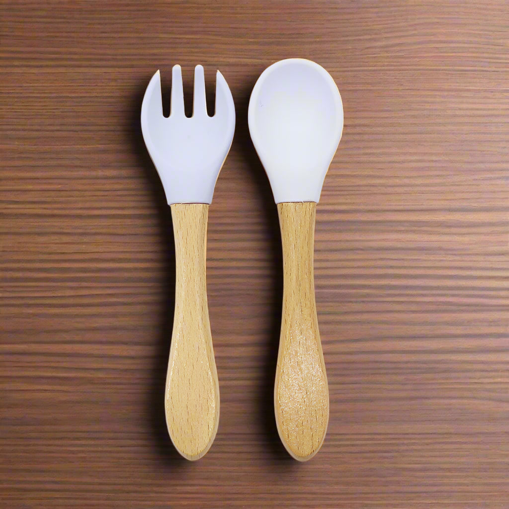 Ergonomic baby training fork and spoon set designed for self-feeding. BPA-free, non-toxic, and perfect for baby-led weaning and toddler meals.