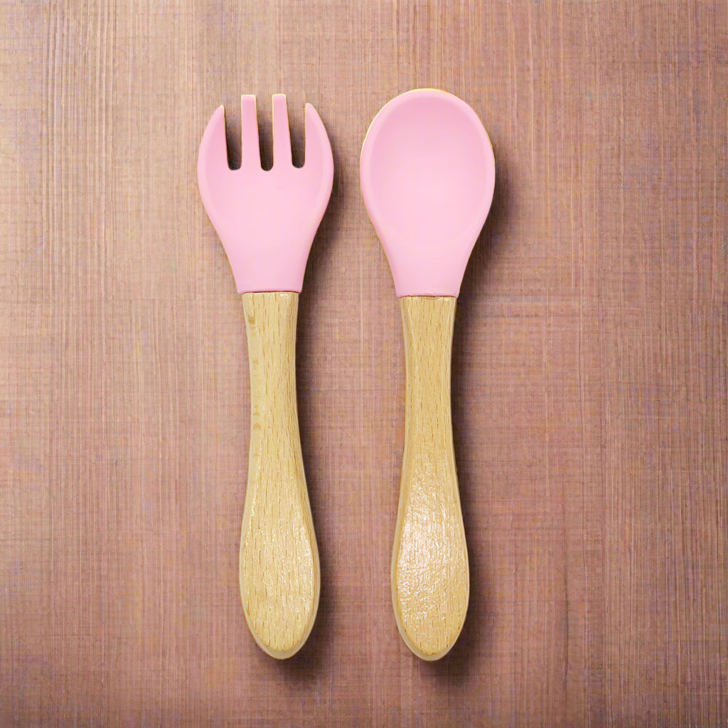 Ergonomic baby training fork and spoon set designed for self-feeding. BPA-free, non-toxic, and perfect for baby-led weaning and toddler meals.
