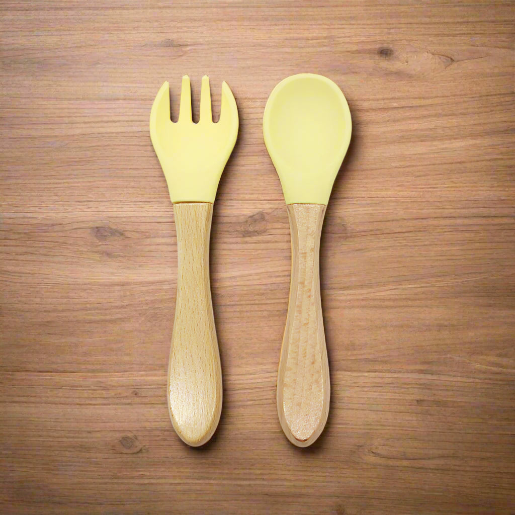 Ergonomic baby training fork and spoon set designed for self-feeding. BPA-free, non-toxic, and perfect for baby-led weaning and toddler meals.