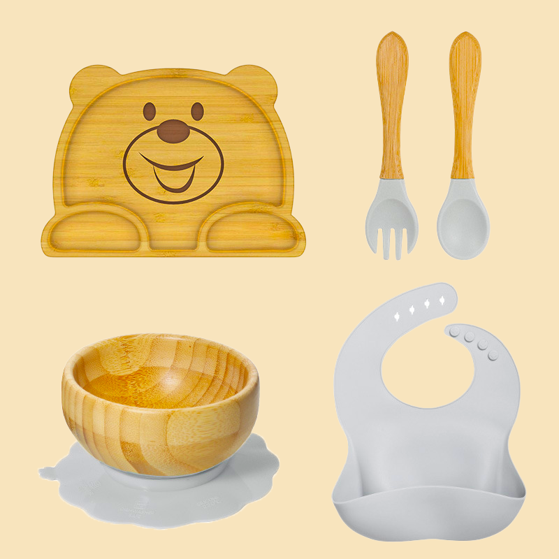 Eco-friendly bamboo suction bowl and waterproof silicone bib set for babies. Non-toxic, BPA-free, and perfect for baby-led weaning and mess-free feeding