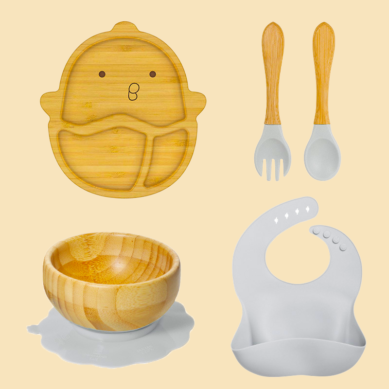 Eco-friendly bamboo suction bowl and waterproof silicone bib set for babies. Non-toxic, BPA-free, and perfect for baby-led weaning and mess-free feeding