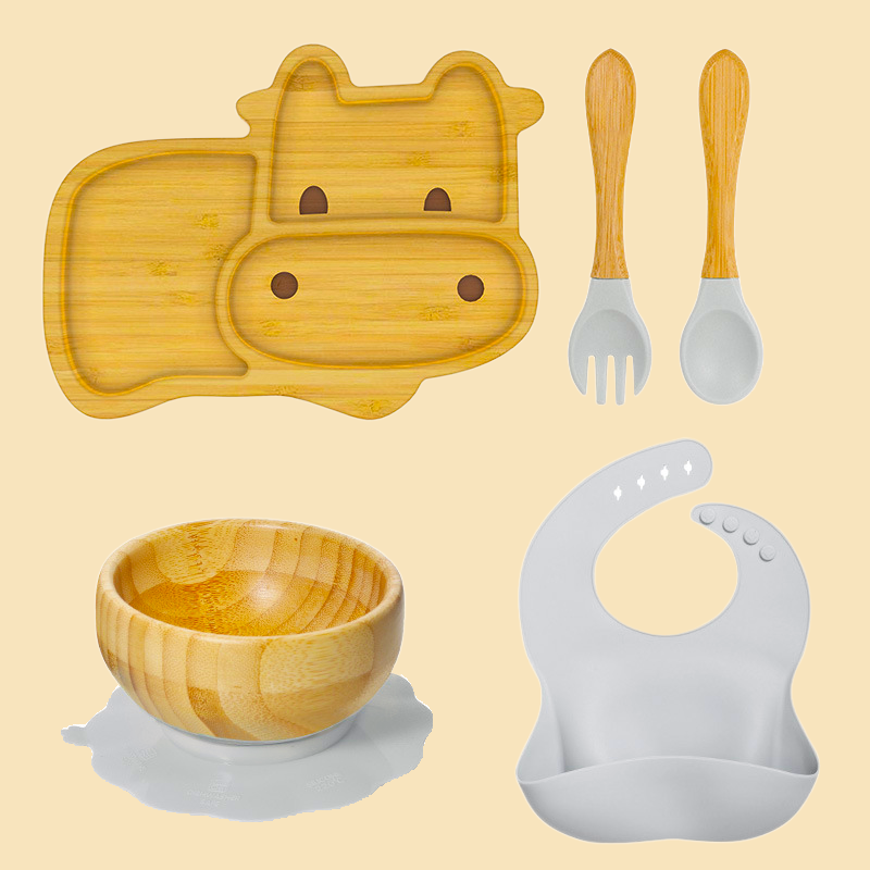Eco-friendly bamboo suction bowl and waterproof silicone bib set for babies. Non-toxic, BPA-free, and perfect for baby-led weaning and mess-free feeding