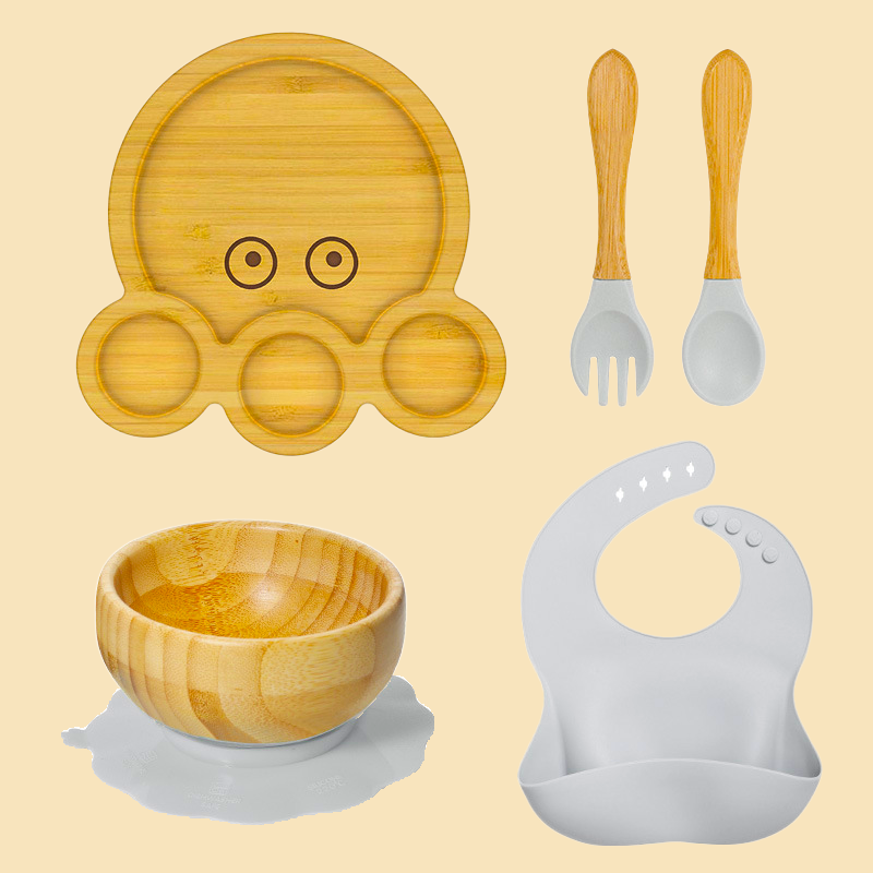 Eco-friendly bamboo suction bowl and waterproof silicone bib set for babies. Non-toxic, BPA-free, and perfect for baby-led weaning and mess-free feeding