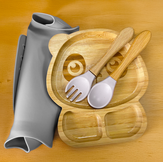 Eco-friendly bamboo suction bowl and waterproof silicone bib set for babies. Non-toxic, BPA-free, and perfect for baby-led weaning and mess-free feeding